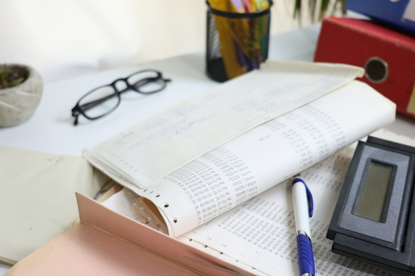 Paperwork, calculator and pen on a desk