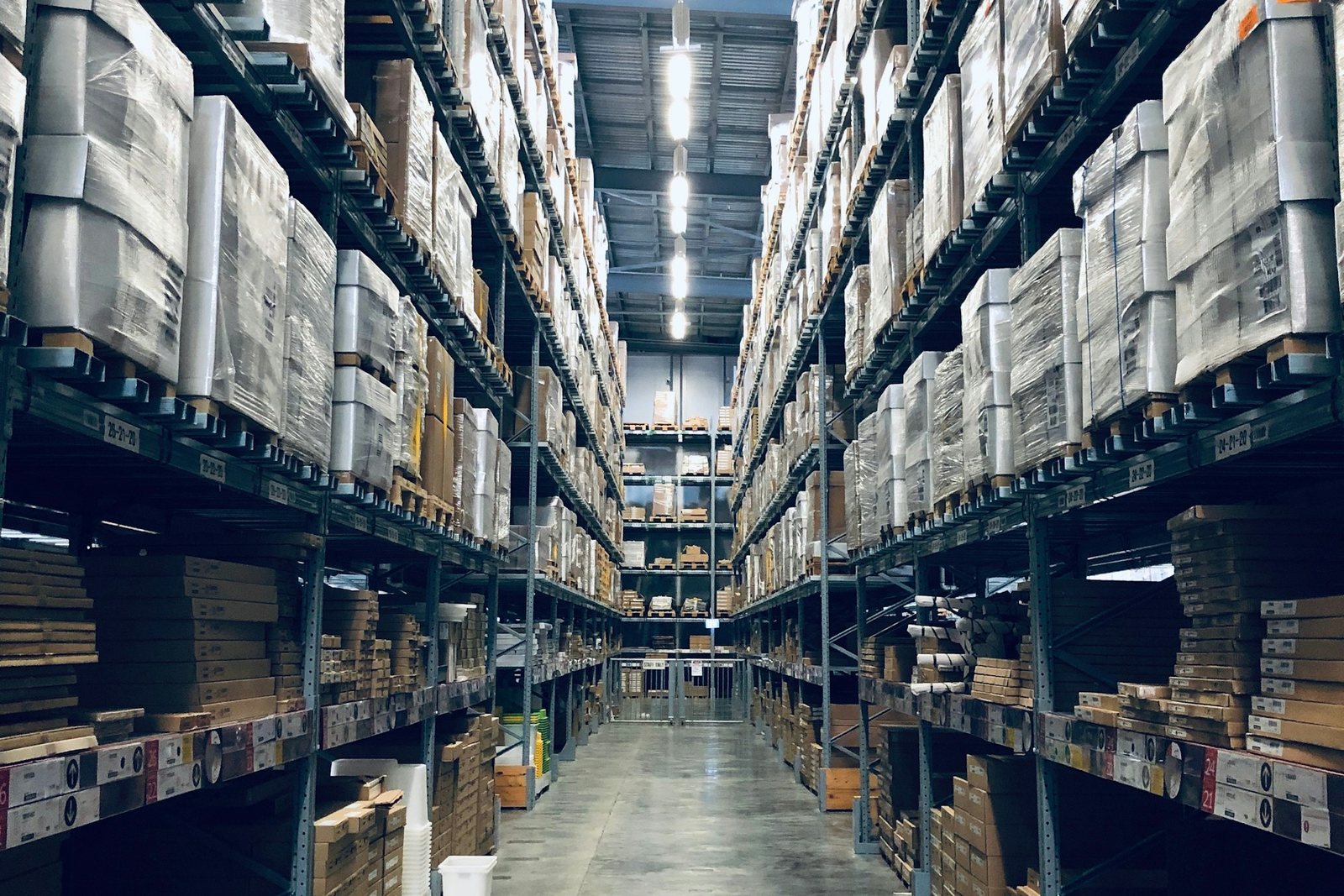 Palletised goods on tall warehouse shelves