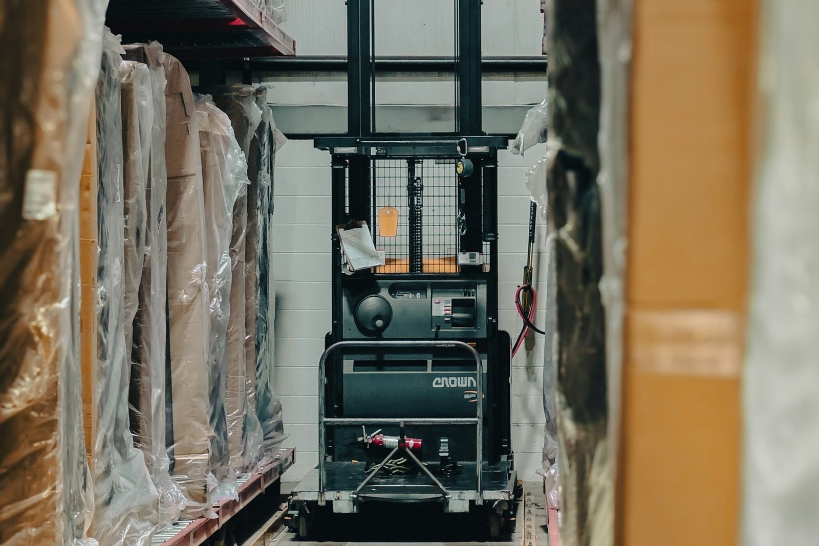 Warehouse aisle with palletised inventory and handling equipment